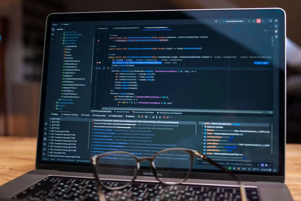 Portátil con código de programación para plugin a medida de CMS - desarrollo de software personalizado
